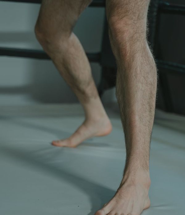 Man in a focused power stance during a workout.